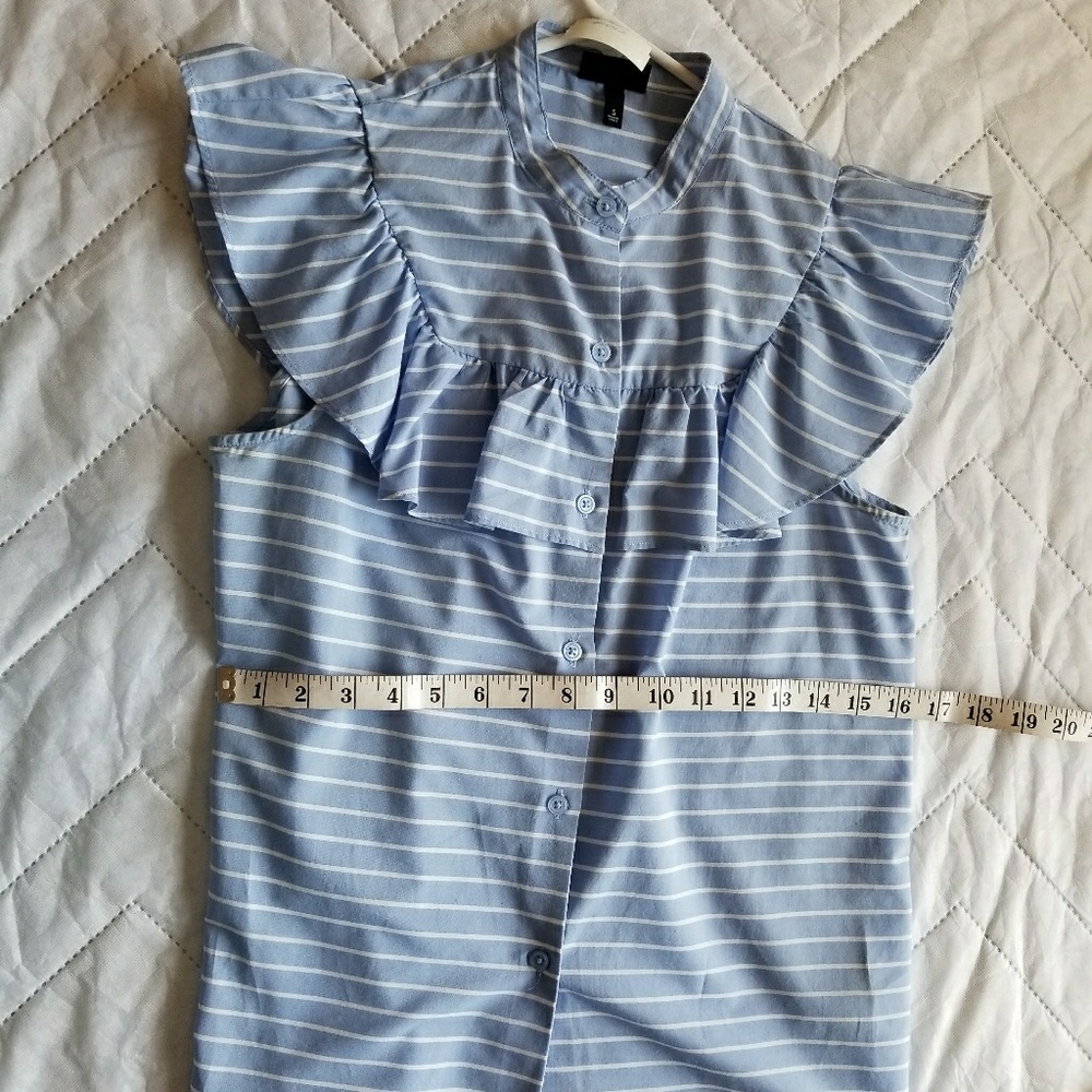 A no sleeve stripped ruffled blouse.